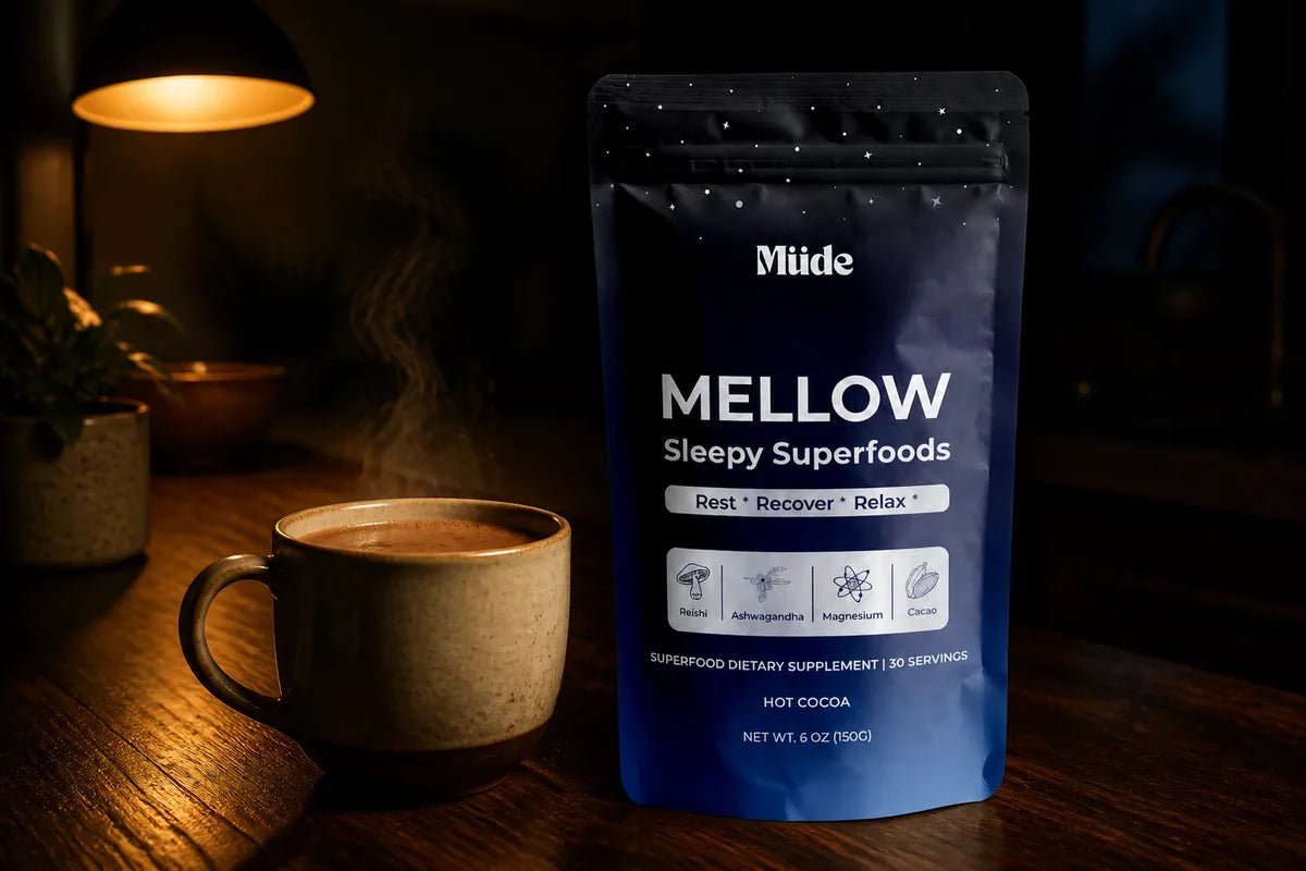 img2img from ~/Projects/mude/assets/hero-mellow.png. Mellow pouch on a dark wooden kitchen counter beside a warm mug of cocoa, steam rising,