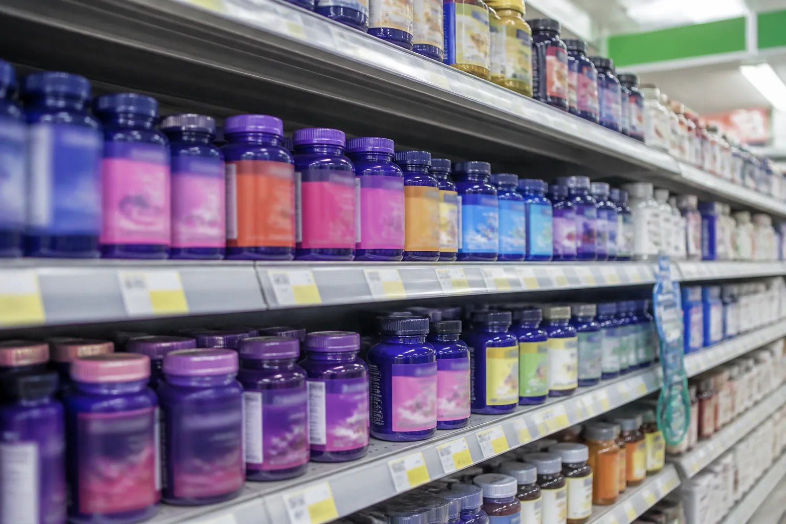 Drugstore supplement aisle, rows of gummy supplement bottles under retail lighting