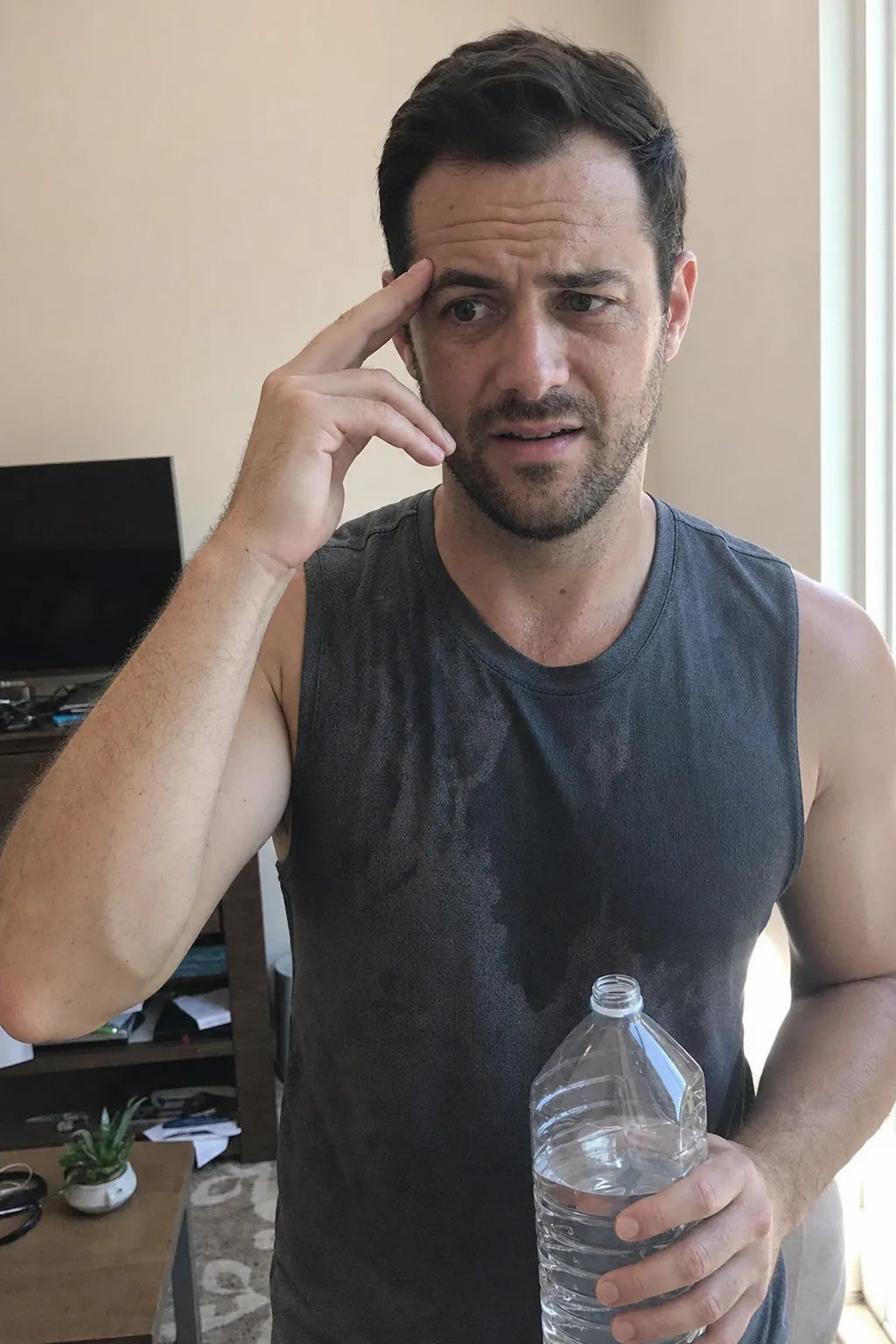 A man hydrated and clear-headed at home.